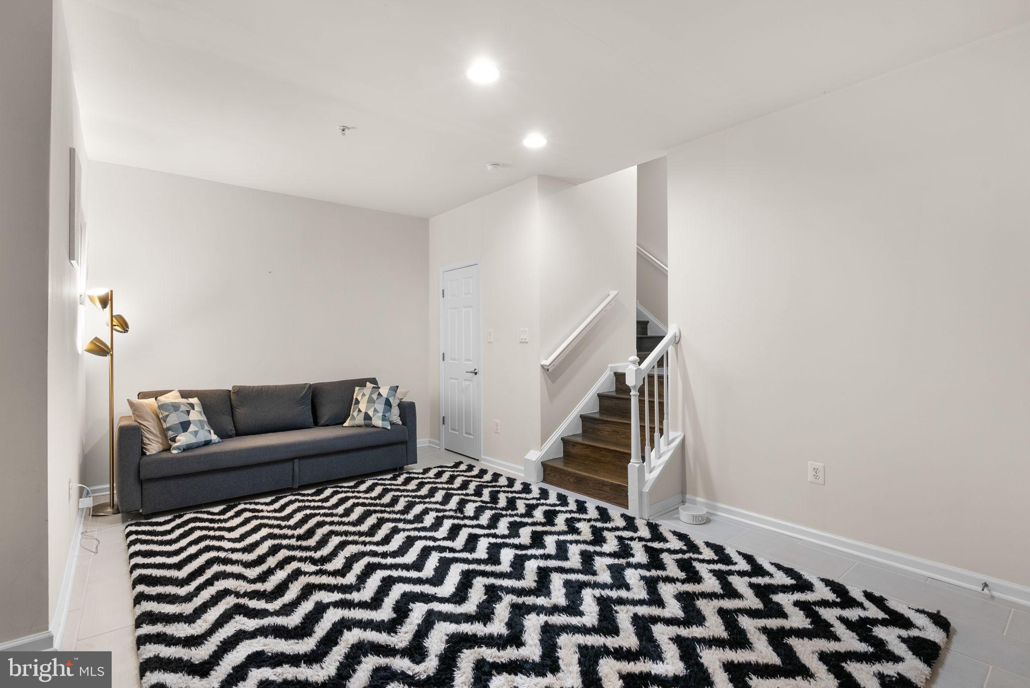 1222 Gaither Road Rockville, MD 20850 - Photo 25 of 42 a bedroom with a bed and a black white checkered floor