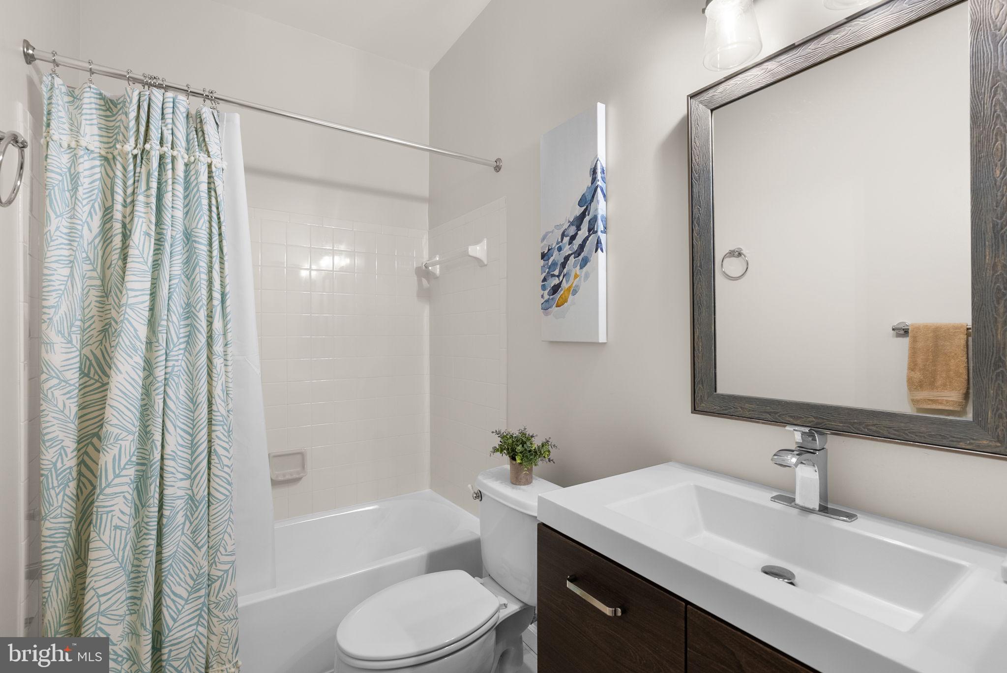1222 Gaither Road Rockville, MD 20850 - Photo 26 of 42 a bathroom with a sink toilet and shower
