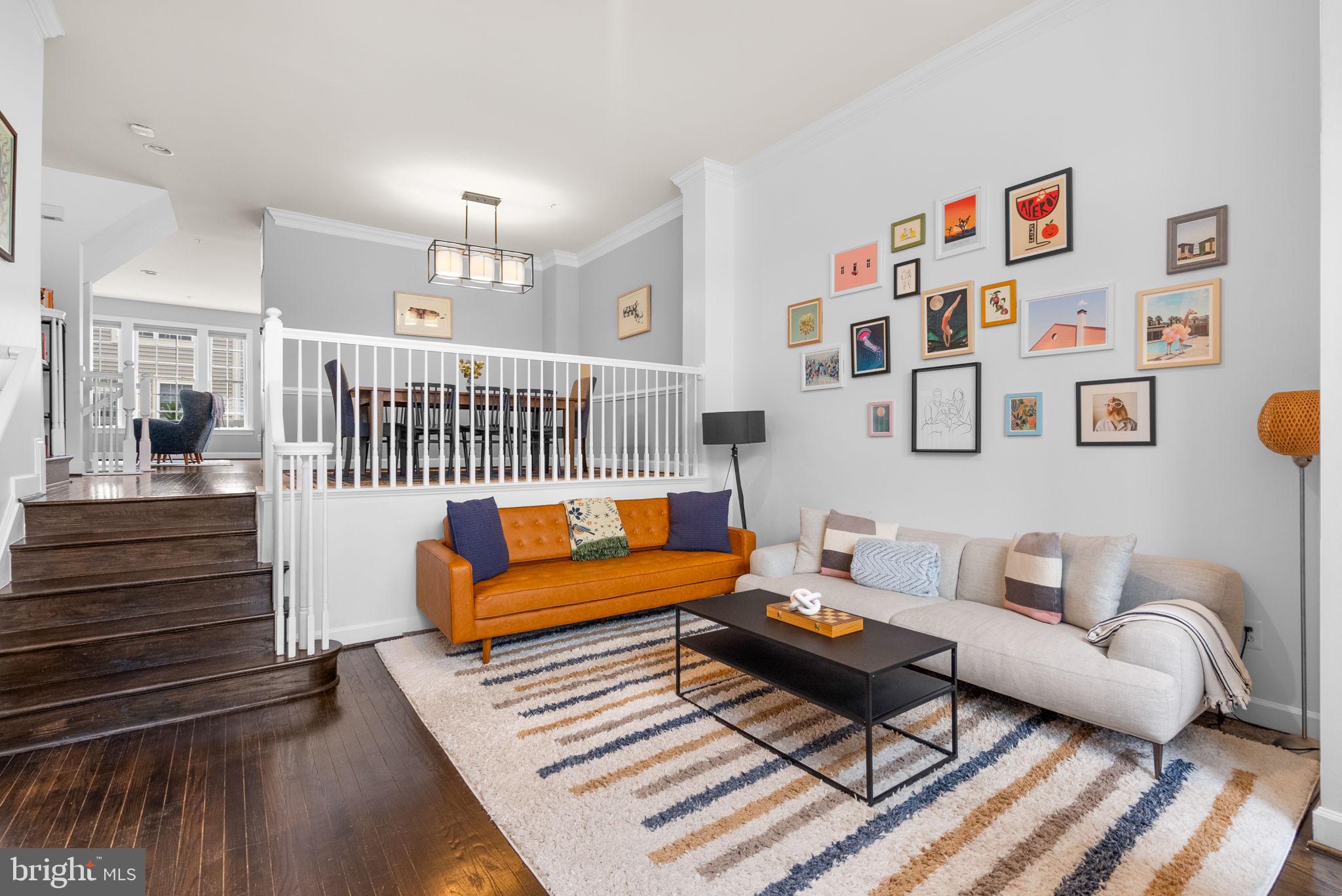 1222 Gaither Road Rockville, MD 20850 - Photo 4 of 42 a living room with furniture a rug and a wall painting