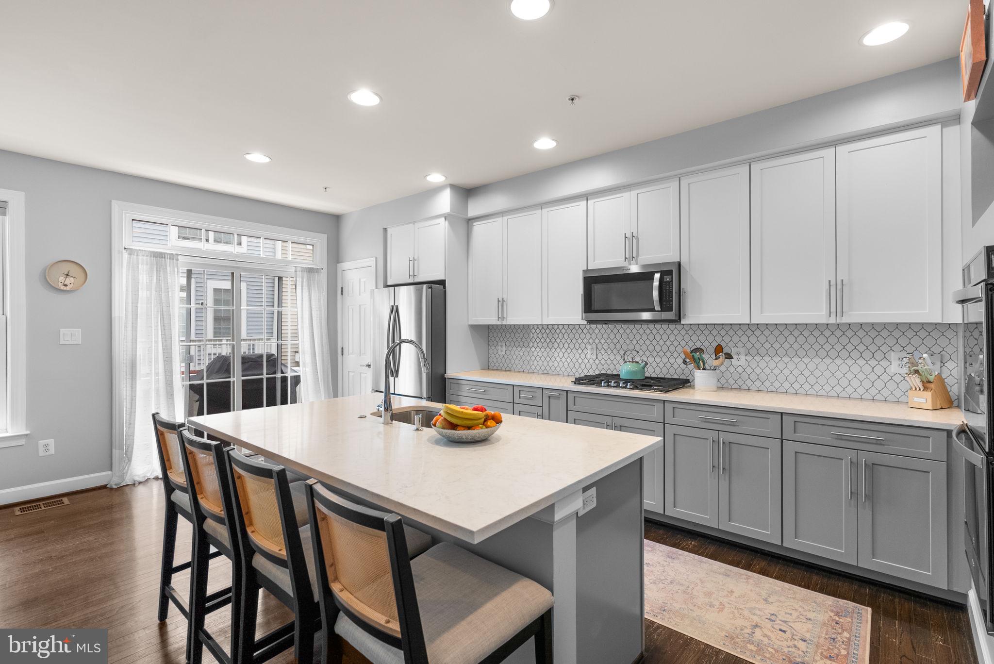 1222 Gaither Road Rockville, MD 20850 - Photo 9 of 42 a kitchen with a sink a stove a table and chairs