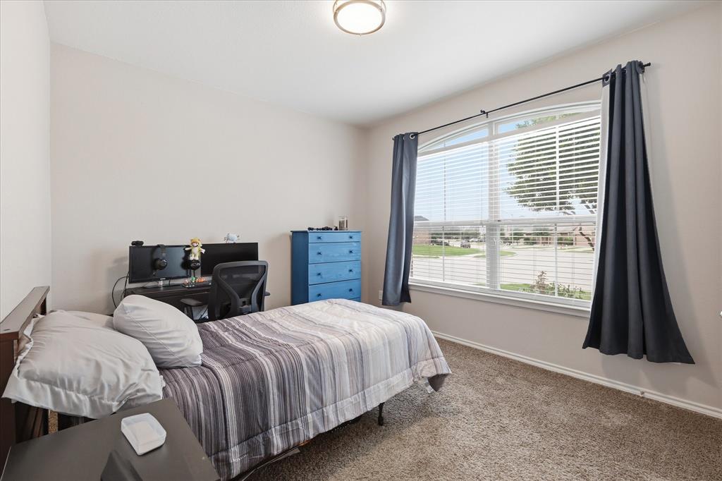 11500 Starlight Ranch Fort Worth, TX 76052 - Photo 27 of 40 This room features light-colored walls, carpeted flooring, and a large window with blinds and dark curtains