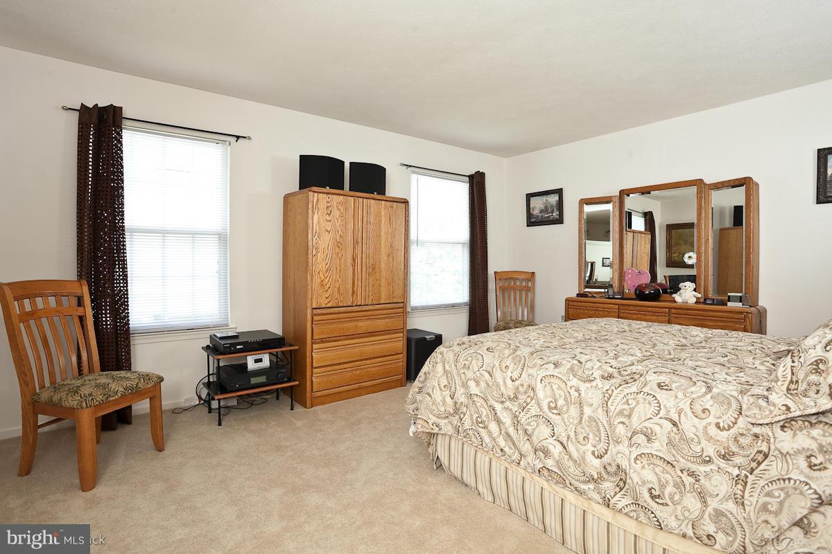 7519 Stream Crossing Road Baltimore, MD 21209 - Photo 11 of 16 a bedroom with a bed and a television