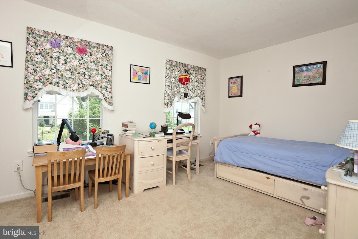 7519 Stream Crossing Road Baltimore, MD 21209 - Photo 13 of 16 a room with a bed and a table