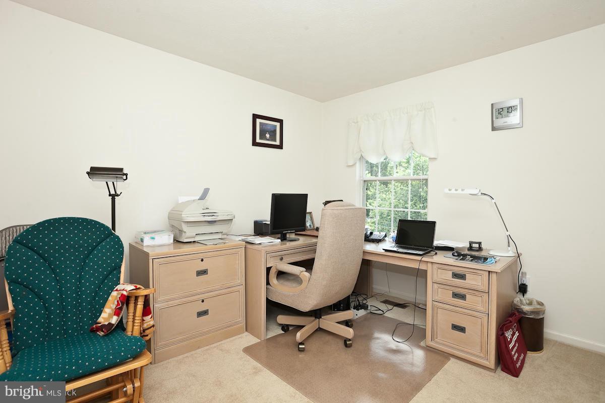 7519 Stream Crossing Road Baltimore, MD 21209 - Photo 14 of 16 a view of a workspace with furniture and a window