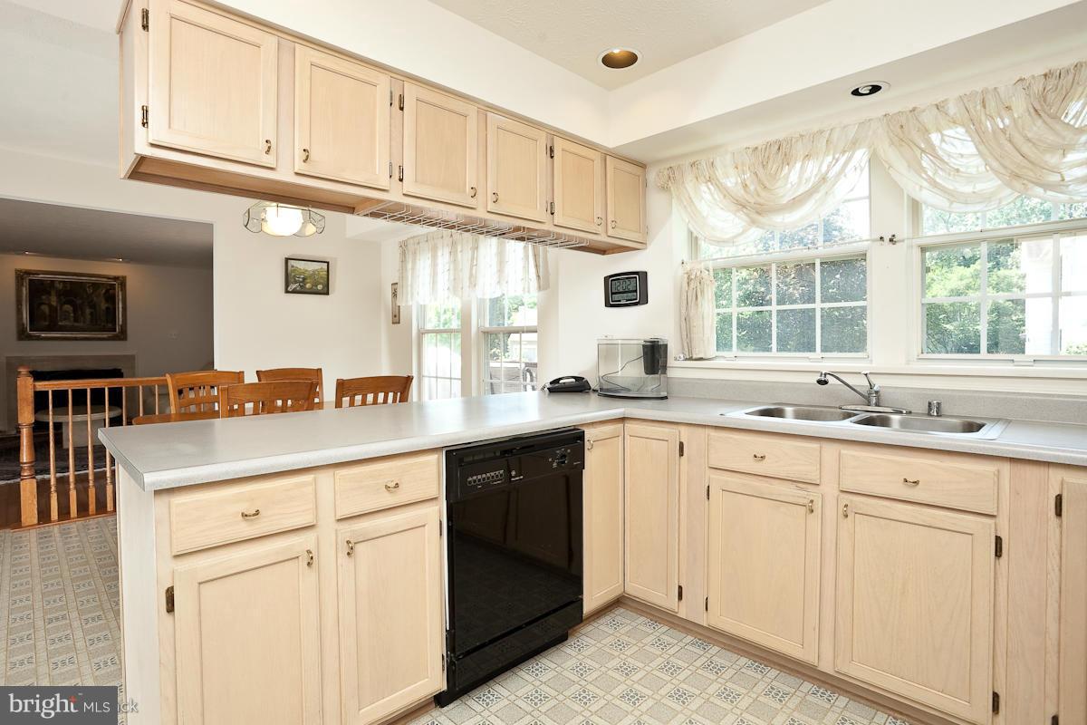 7519 Stream Crossing Road Baltimore, MD 21209 - Photo 6 of 16 a kitchen with sink cabinets and window