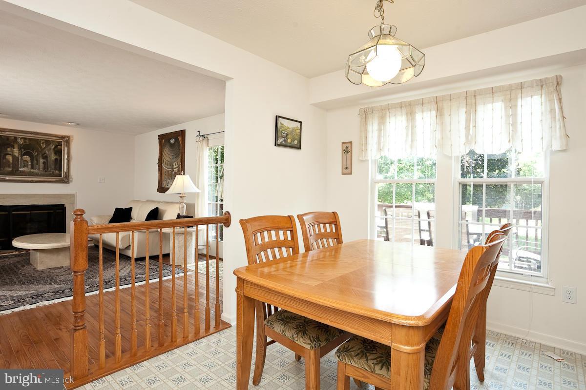 7519 Stream Crossing Road Baltimore, MD 21209 - Photo 7 of 16 a view of a dining room with furniture window and wooden floor