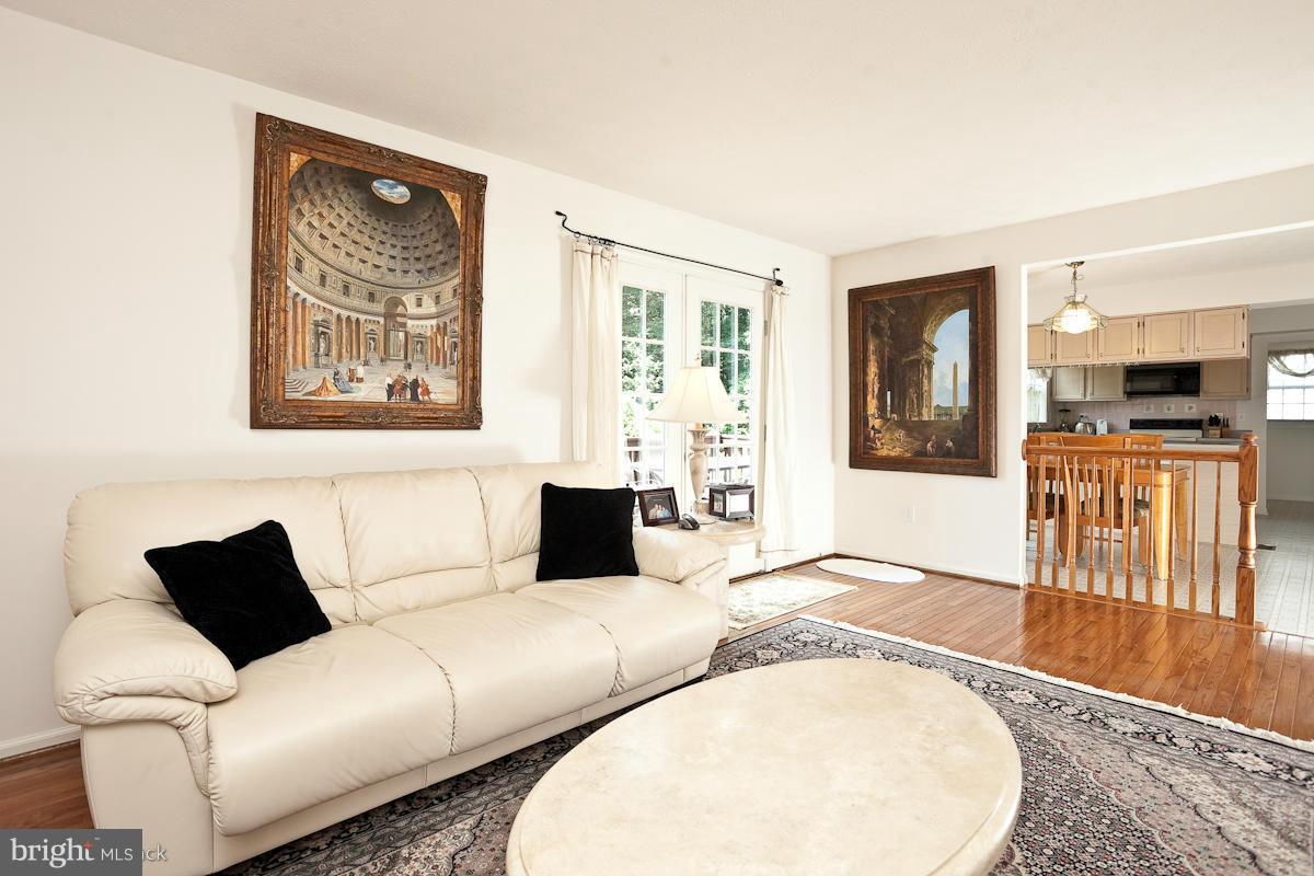 7519 Stream Crossing Road Baltimore, MD 21209 - Photo 9 of 16 a living room with furniture and a flat screen tv