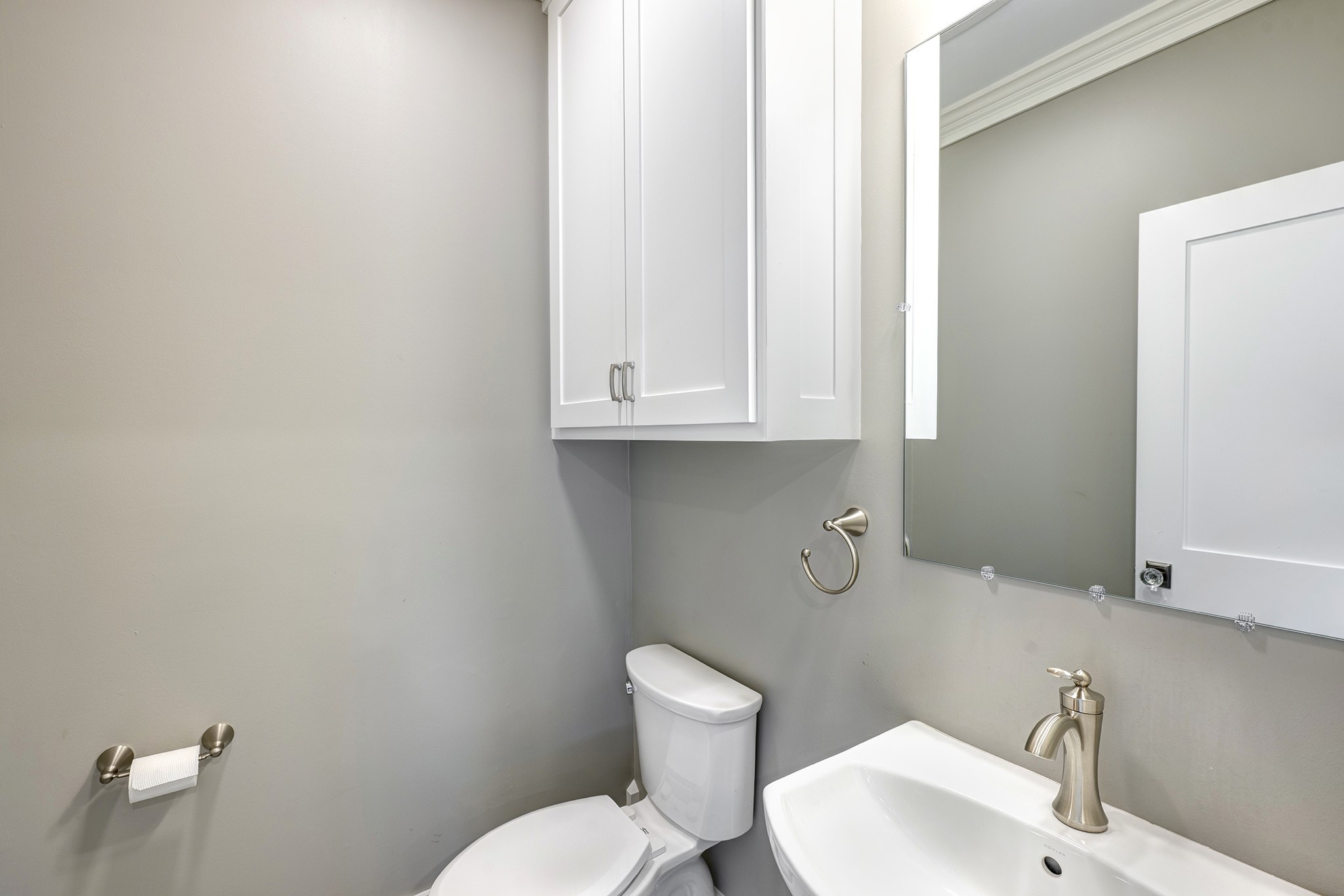 1314 Harvard Street Houston, TX 77008 - Photo 24 of 36 a bathroom with a toilet a sink and mirror