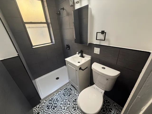 a white toilet sitting next to a bathroom sink
