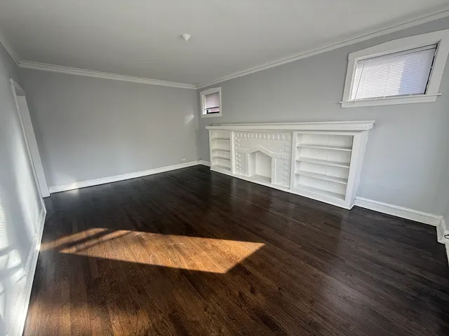 an empty room with wooden floor