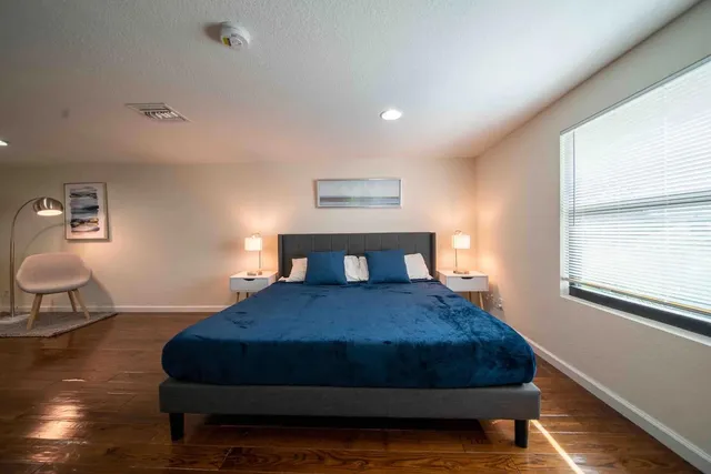 a bedroom with a bed and window