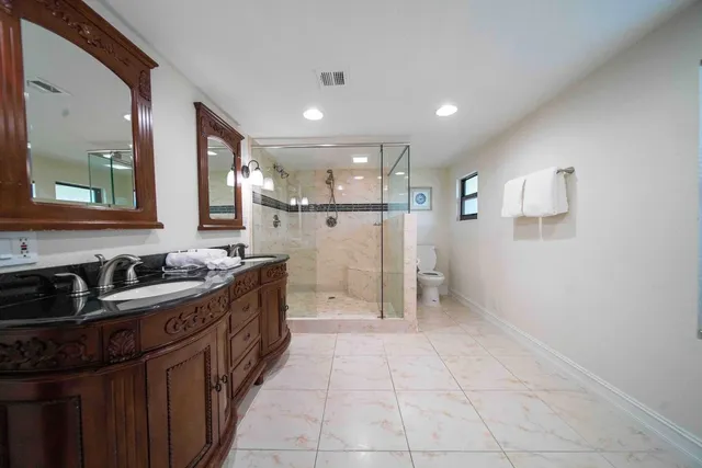 a kitchen with refrigerator and cabinets