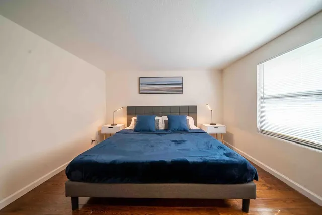 a bedroom with a bed and window