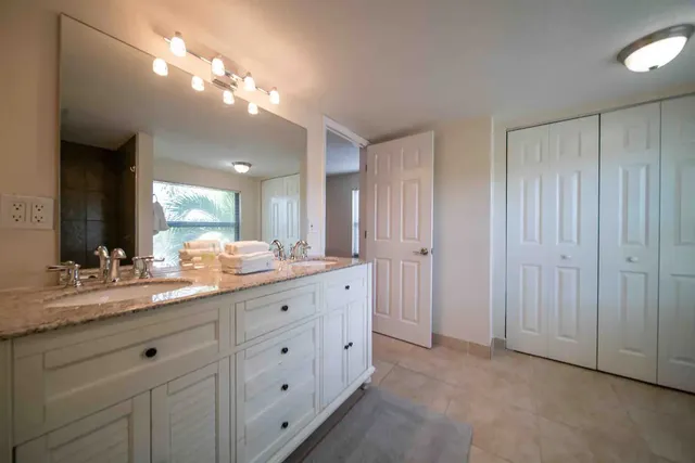 a bathroom with a double vanity sink and a mirror