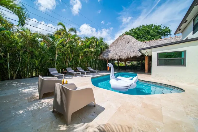a view of a patio with couches and potted plants
