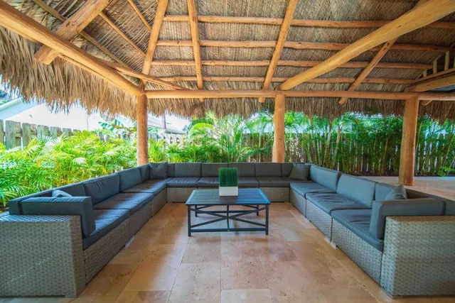 a outdoor living space with furniture and a black umbrella