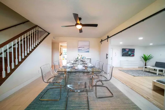 a view of a dining room with furniture and a chandelier
