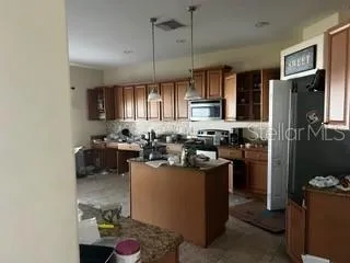 a kitchen with sink refrigerator and cabinets