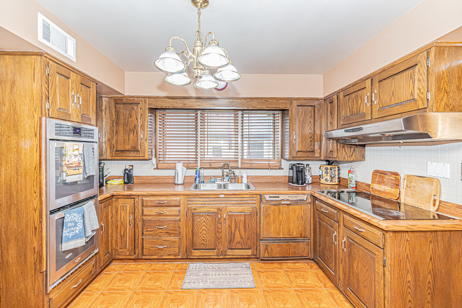 2256 North Home Avenue Park Ridge, IL 60068 - Photo 9 of 40 a kitchen with stainless steel appliances a sink stove and cabinets