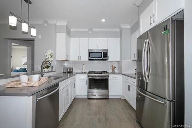 a kitchen with a refrigerator sink and microwave