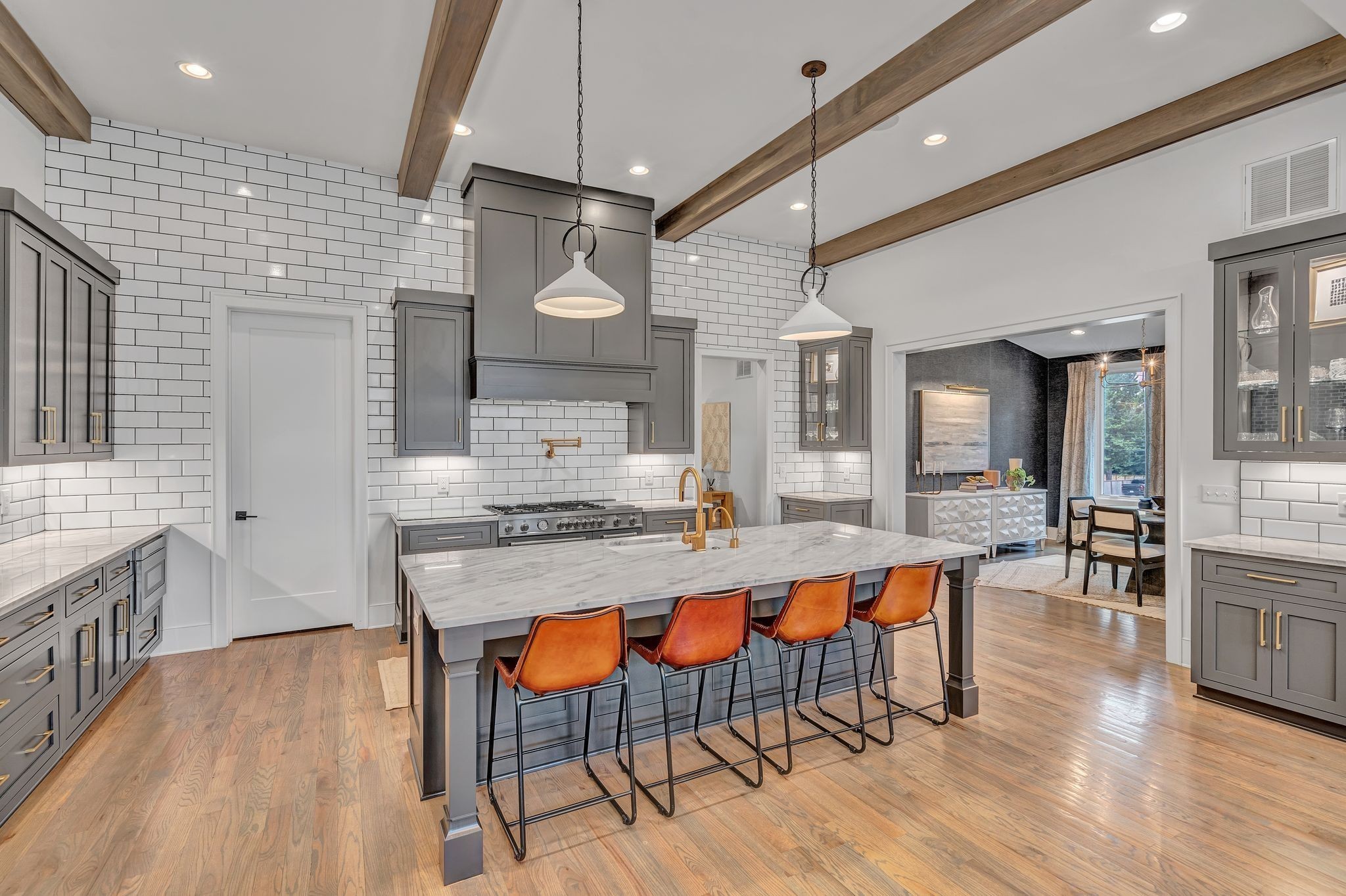6029 Sedberry Road Nashville, TN 37205 - Photo 17 of 68 a large kitchen with granite countertop a stove a sink a dining table and chairs with wooden floor