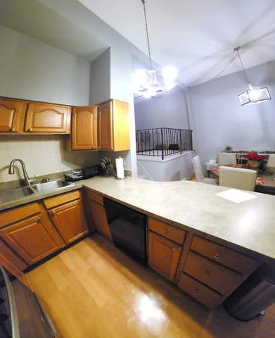 a large kitchen with kitchen island a large counter space a sink and appliances