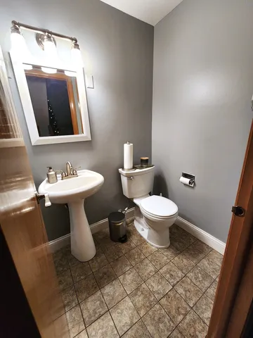 a white toilet sitting next to a bathroom sink