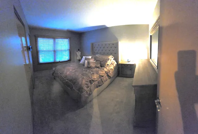 a bed room with a bed and a window