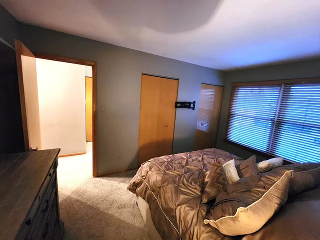 a bedroom with a bed and window