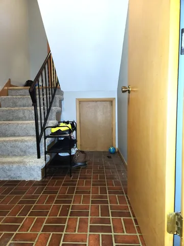 a view of a entryway door with wooden floor