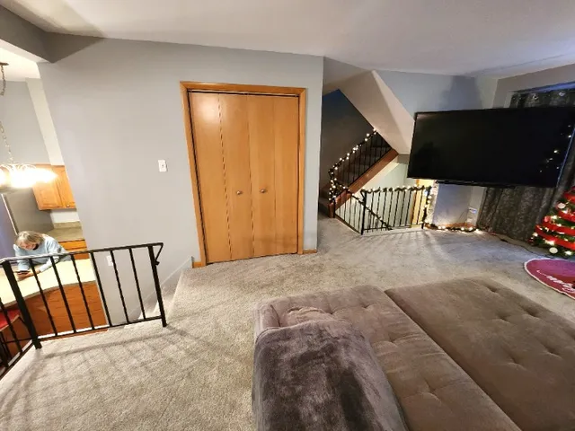 a view of a hallway to a livingroom with furniture