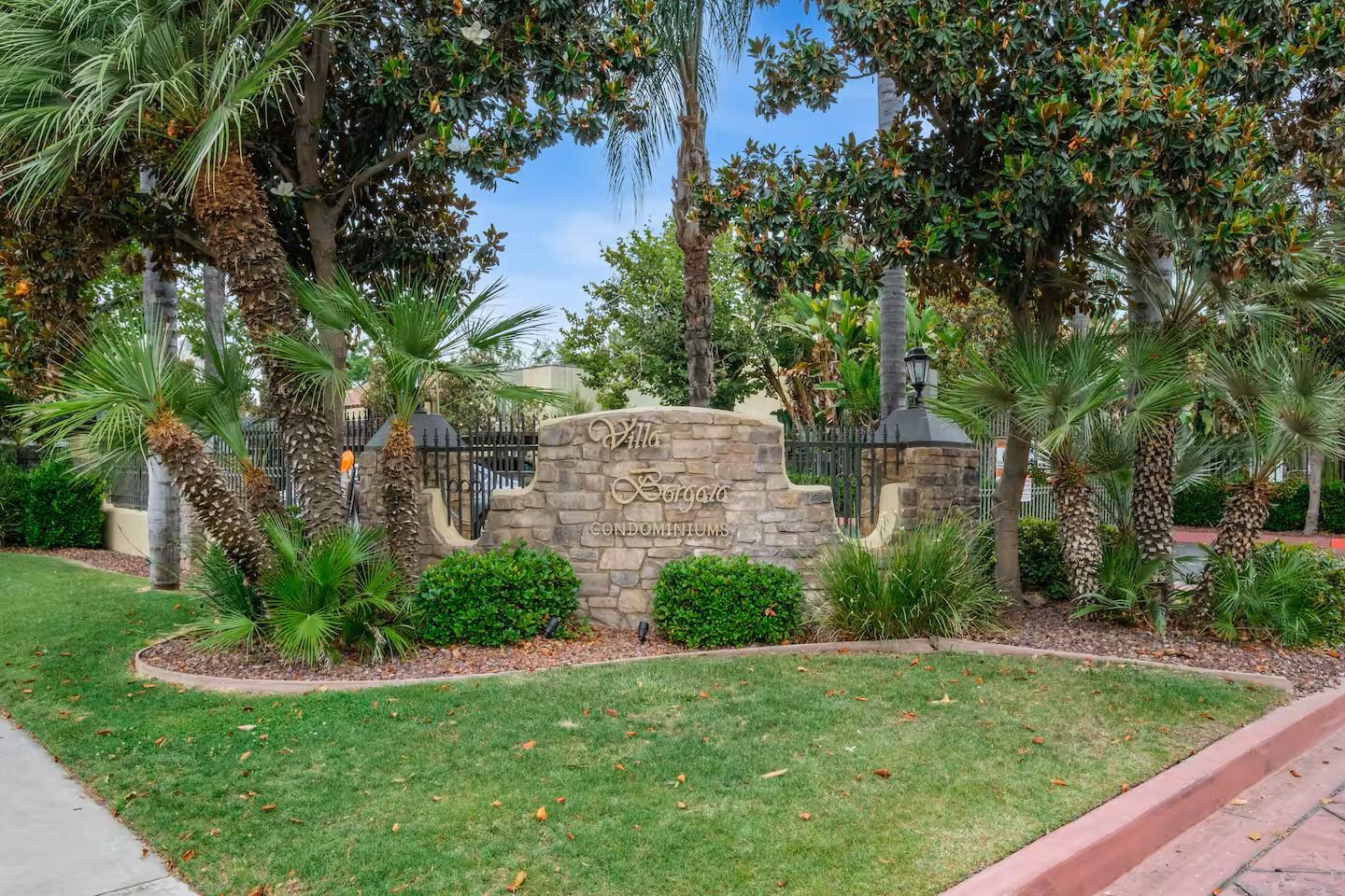 2881 Huntington Boulevard, Unit 225 Fresno, CA 93721 - Photo 2 of 16 a view of a backyard with large trees