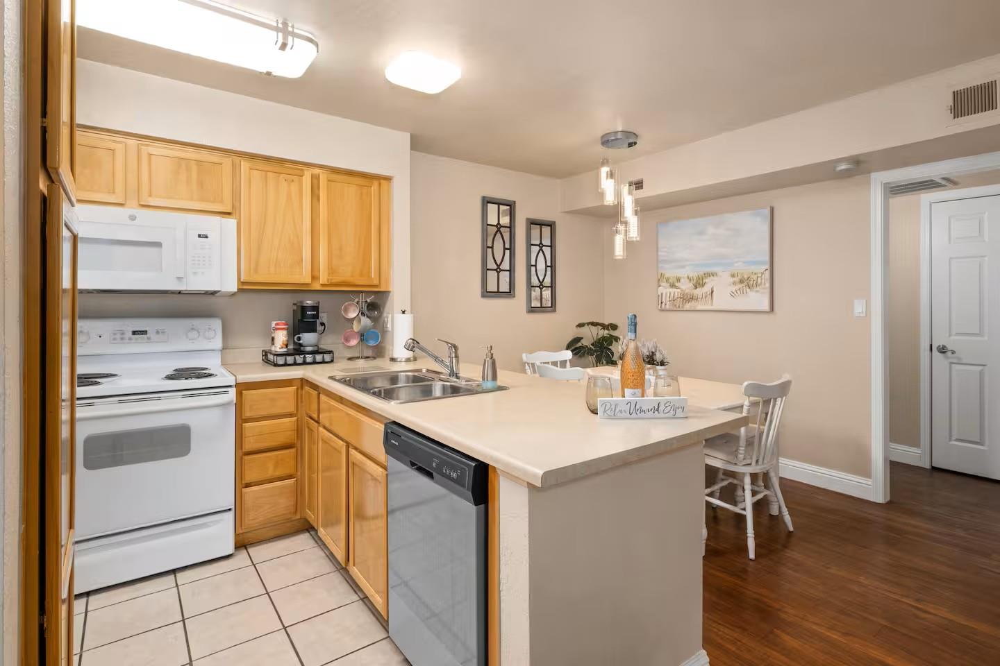 2881 Huntington Boulevard, Unit 225 Fresno, CA 93721 - Photo 3 of 16 a kitchen with a sink cabinets and wooden floor