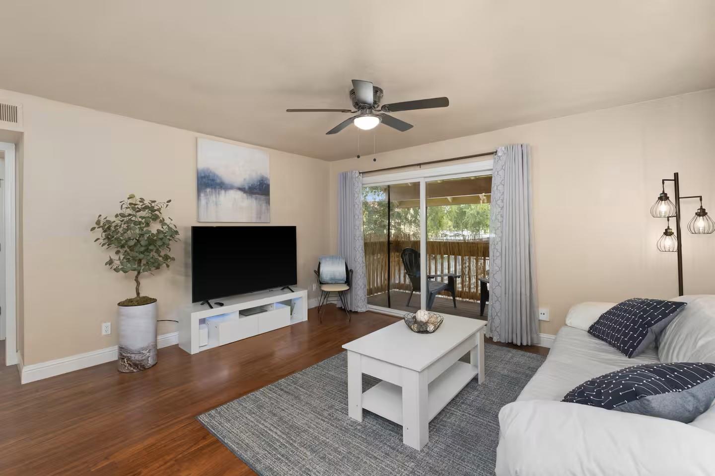 2881 Huntington Boulevard, Unit 225 Fresno, CA 93721 - Photo 4 of 16 a living room with furniture and a flat screen tv