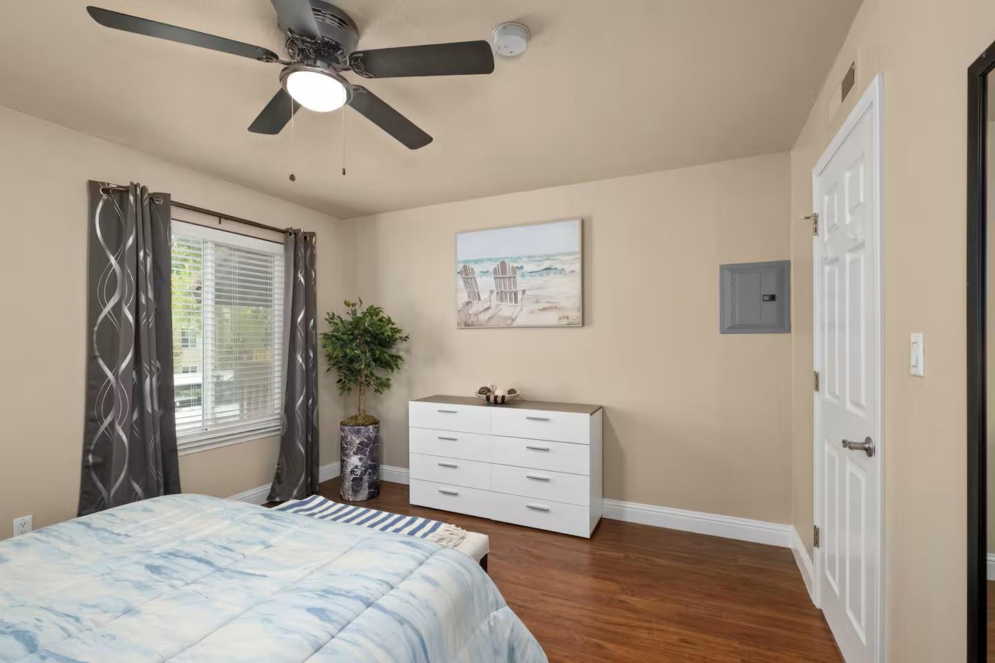 2881 Huntington Boulevard, Unit 225 Fresno, CA 93721 - Photo 6 of 16 a bedroom with a bed and a dresser