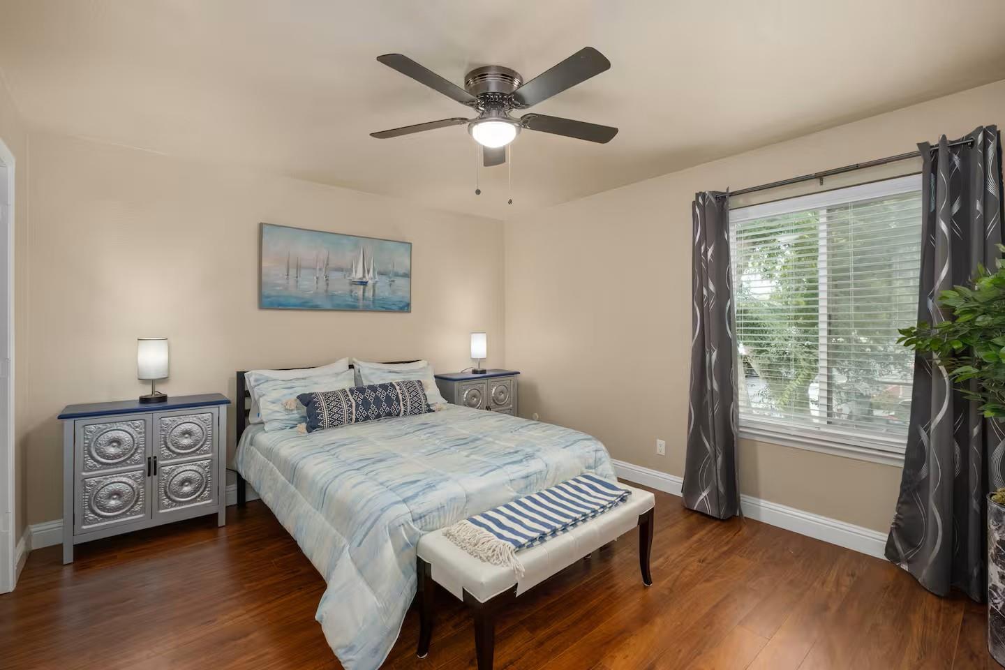 2881 Huntington Boulevard, Unit 225 Fresno, CA 93721 - Photo 7 of 16 a bedroom with a bed and a large window