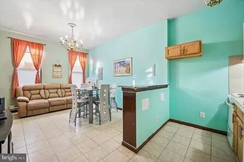 a living room with furniture and a chandelier