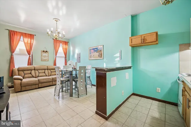 a living room with furniture and a chandelier