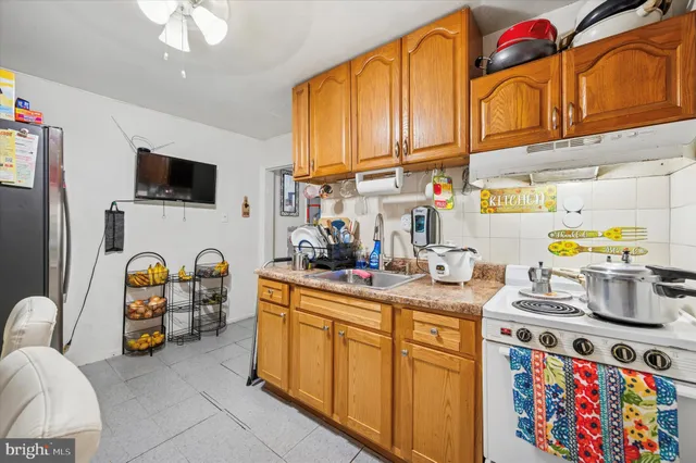 a kitchen with stainless steel appliances granite countertop a stove and a sink