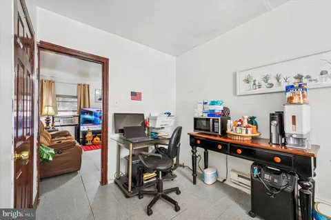 a work room with furniture and a wooden floor