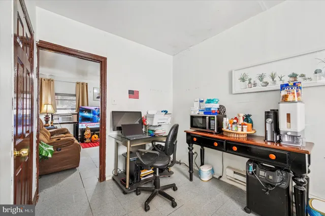a work room with furniture and a wooden floor