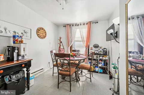 a view of a dining room with furniture and a window