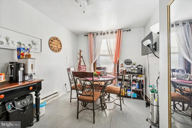 a view of a dining room with furniture and a window