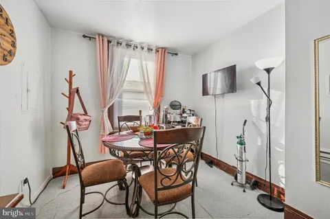a view of a dining room with furniture and a window