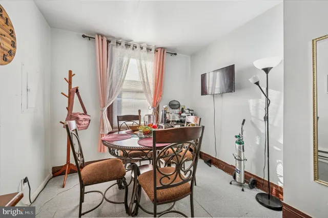a view of a dining room with furniture and a window