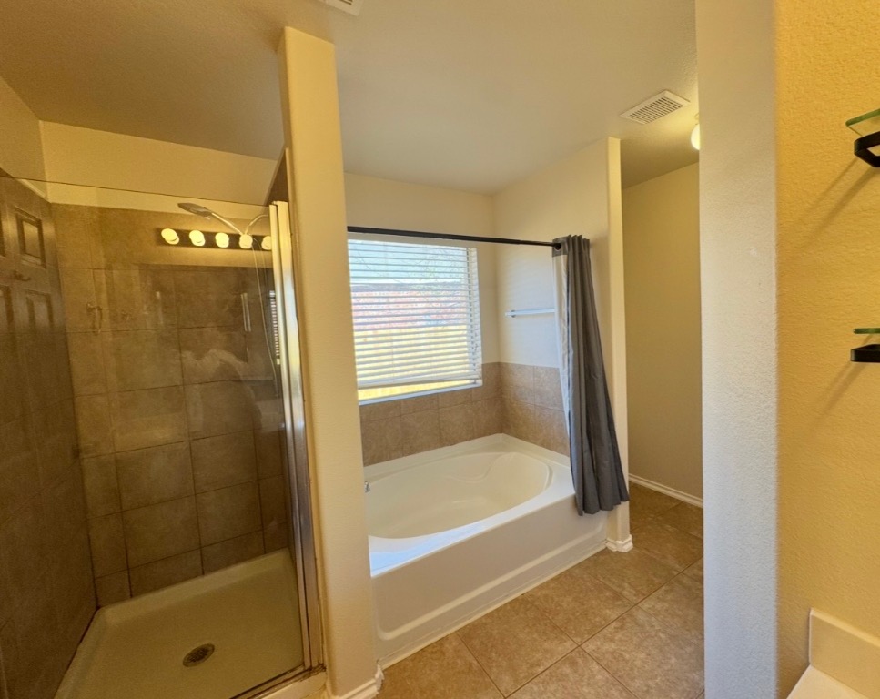 104 Gettysburg Loop Elgin, TX 78621 - Photo 15 of 26 Full bath with a bath, light tile patterned floors, and a stall shower