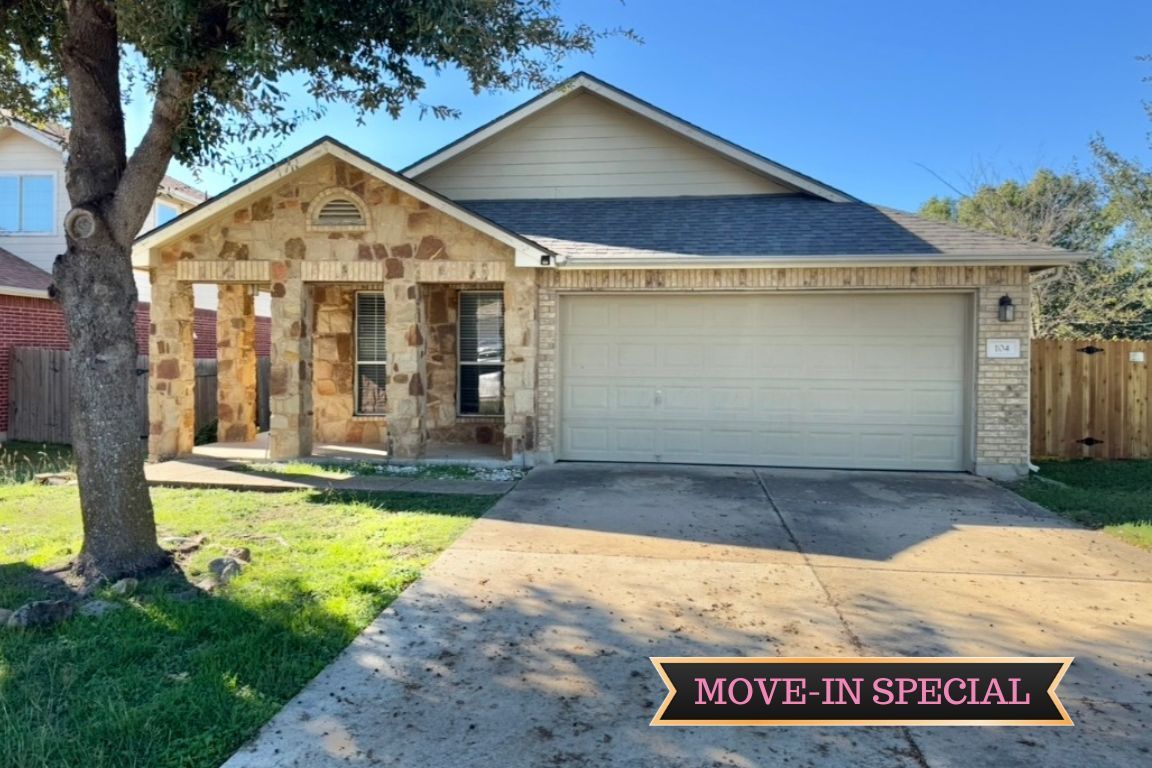104 Gettysburg Loop Elgin, TX 78621 - Photo 2 of 26 View of front of property featuring a porch, driveway, brick siding, roof with shingles, and stone siding