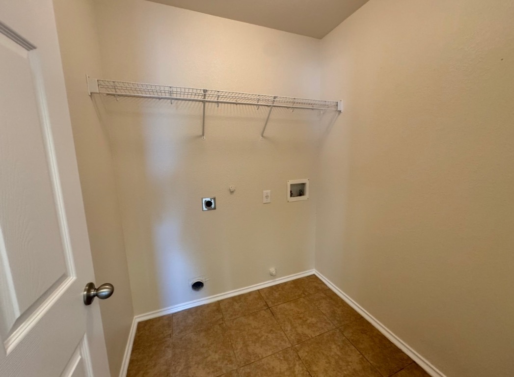 104 Gettysburg Loop Elgin, TX 78621 - Photo 23 of 26 Laundry area featuring hookup for a gas dryer, hookup for a washing machine, dark tile patterned floors, and hookup for an electric dryer