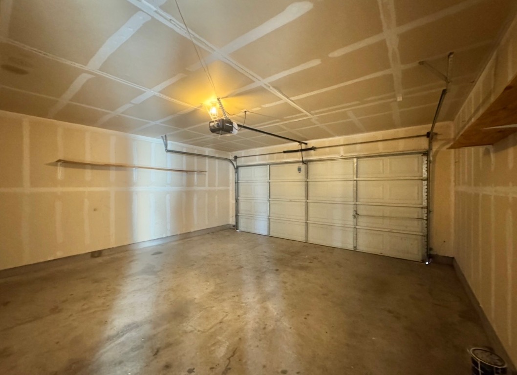 104 Gettysburg Loop Elgin, TX 78621 - Photo 24 of 26 Garage with a garage door opener