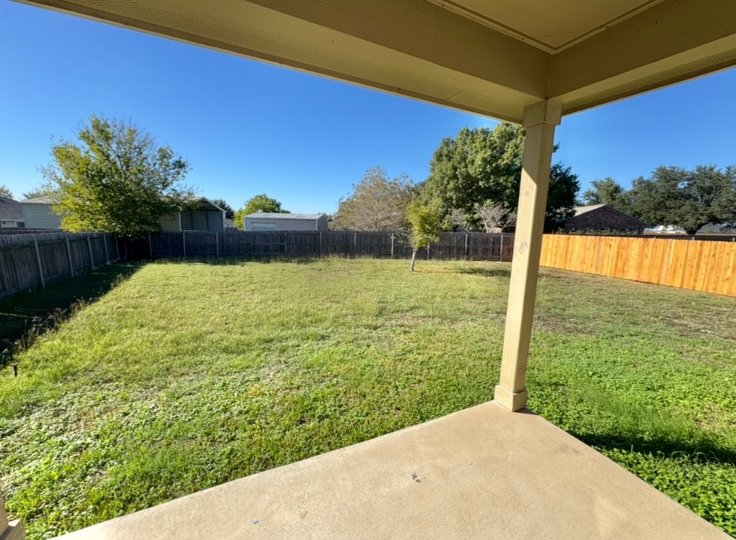 104 Gettysburg Loop Elgin, TX 78621 - Photo 25 of 26 Fenced backyard with a patio area